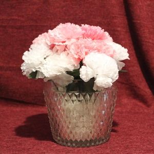 Homemade artificial flowers in glass vase.